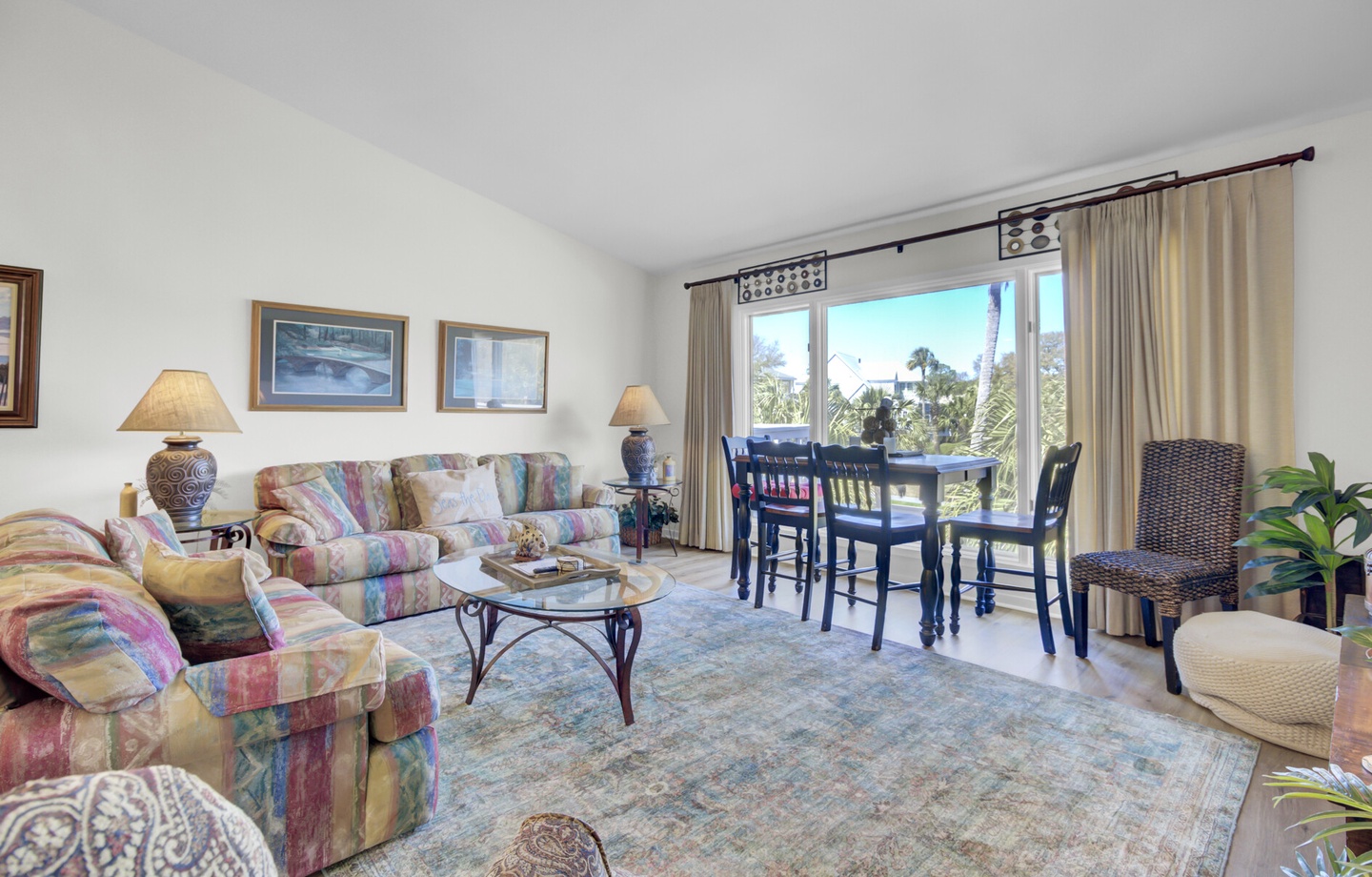 - Gather with loved ones in this sunny open concept space with cozy seating for all - Floor to ceiling windows invite in natural light and beautiful outdoor views - Enjoy casual meals at the high top dining table or unwind with a movie night