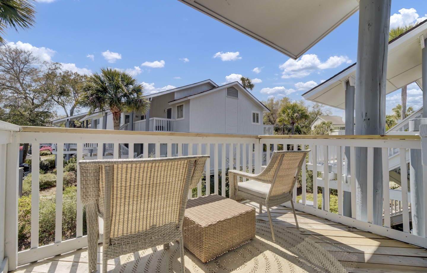 - Start your day with coffee or unwind with a drink on this private outdoor balcony - Comfortable wicker seating and a shade awning create the perfect chill zone - Surrounded by palms and fresh air, your slice of island style relaxation awaits