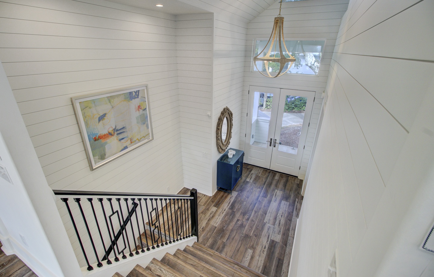 Step into your bright, welcoming entryway where coastal-inspired decor and warm wood floors greet you after a day of exploration.