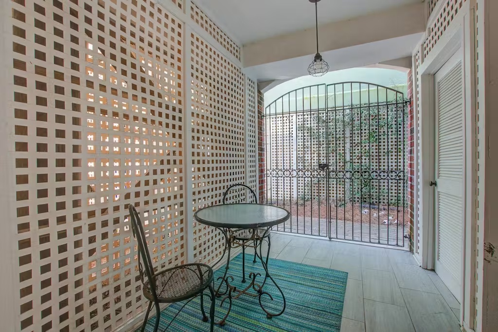 Step into your private courtyard oasis where latticed walls create dappled light patterns, perfect for morning coffee or evening relaxation.