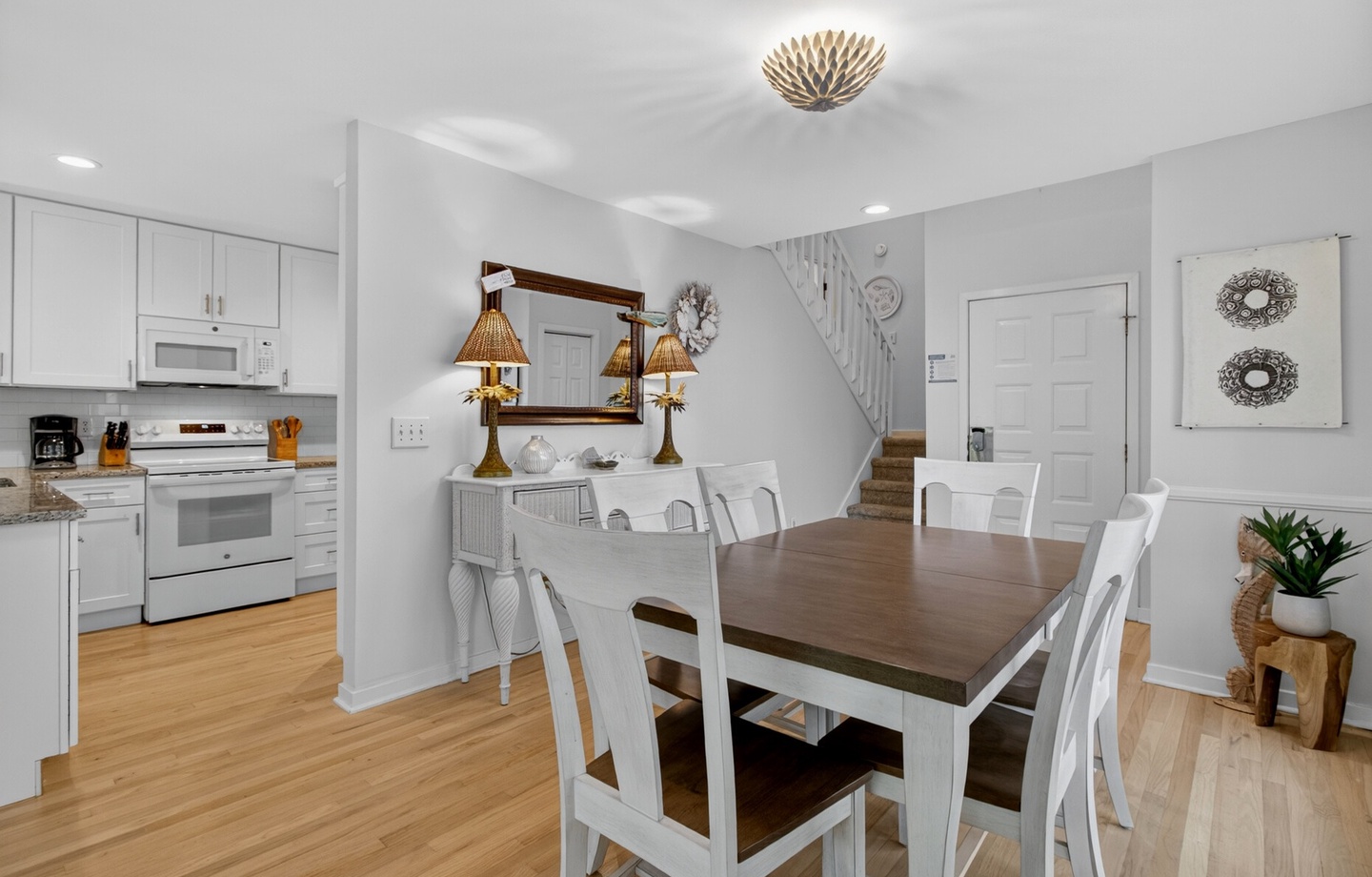 Gather around your spacious dining table for memorable meals, perfectly positioned between the well-equipped kitchen and cozy living spaces.