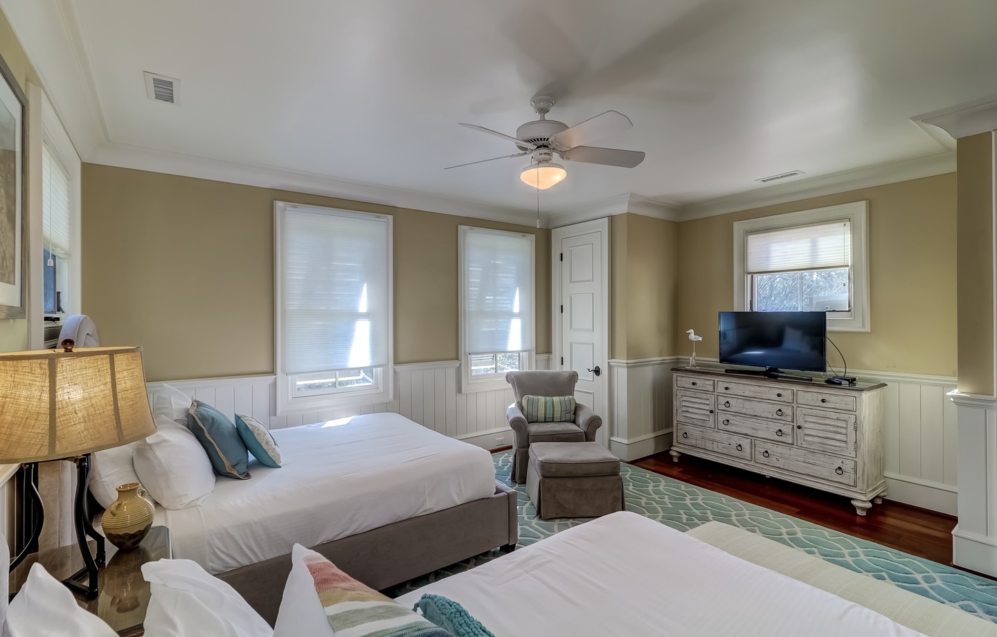 Unwind in your spacious retreat with two comfortable beds, a cozy reading nook, and coastal-inspired décor that invites peaceful slumber.