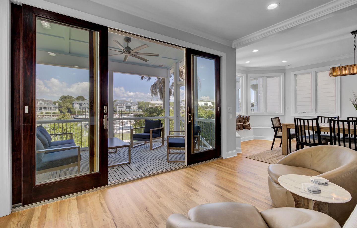 Step into your elegant living space where floor-to-ceiling windows frame stunning marina views, creating the perfect backdrop for relaxation.