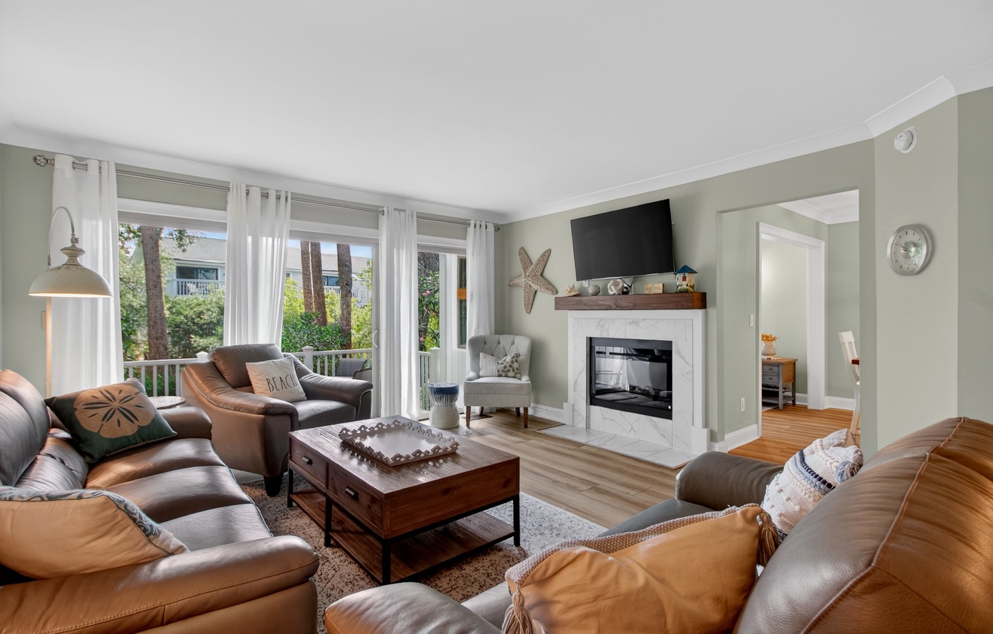 Settle into plush leather sofas by the fireplace, where coastal charm meets modern comfort in your home away from home.