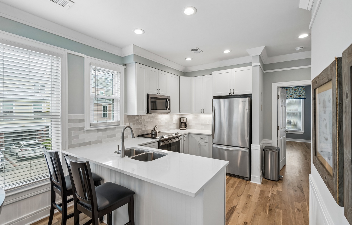 Your fully equipped kitchen awaits with sleek quartz countertops, stainless appliances, and a breakfast bar where you can sip morning coffee.