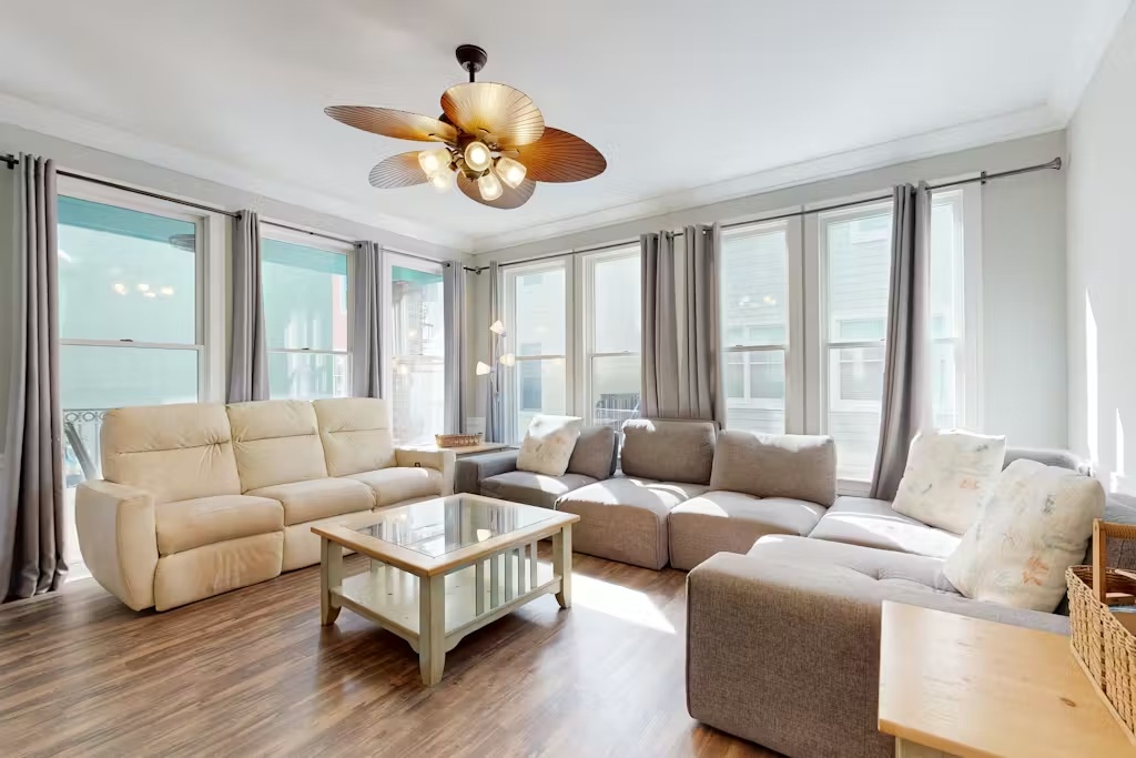 Relax in your bright living room with plush seating, panoramic windows, and warm wood floors that invite endless comfort.