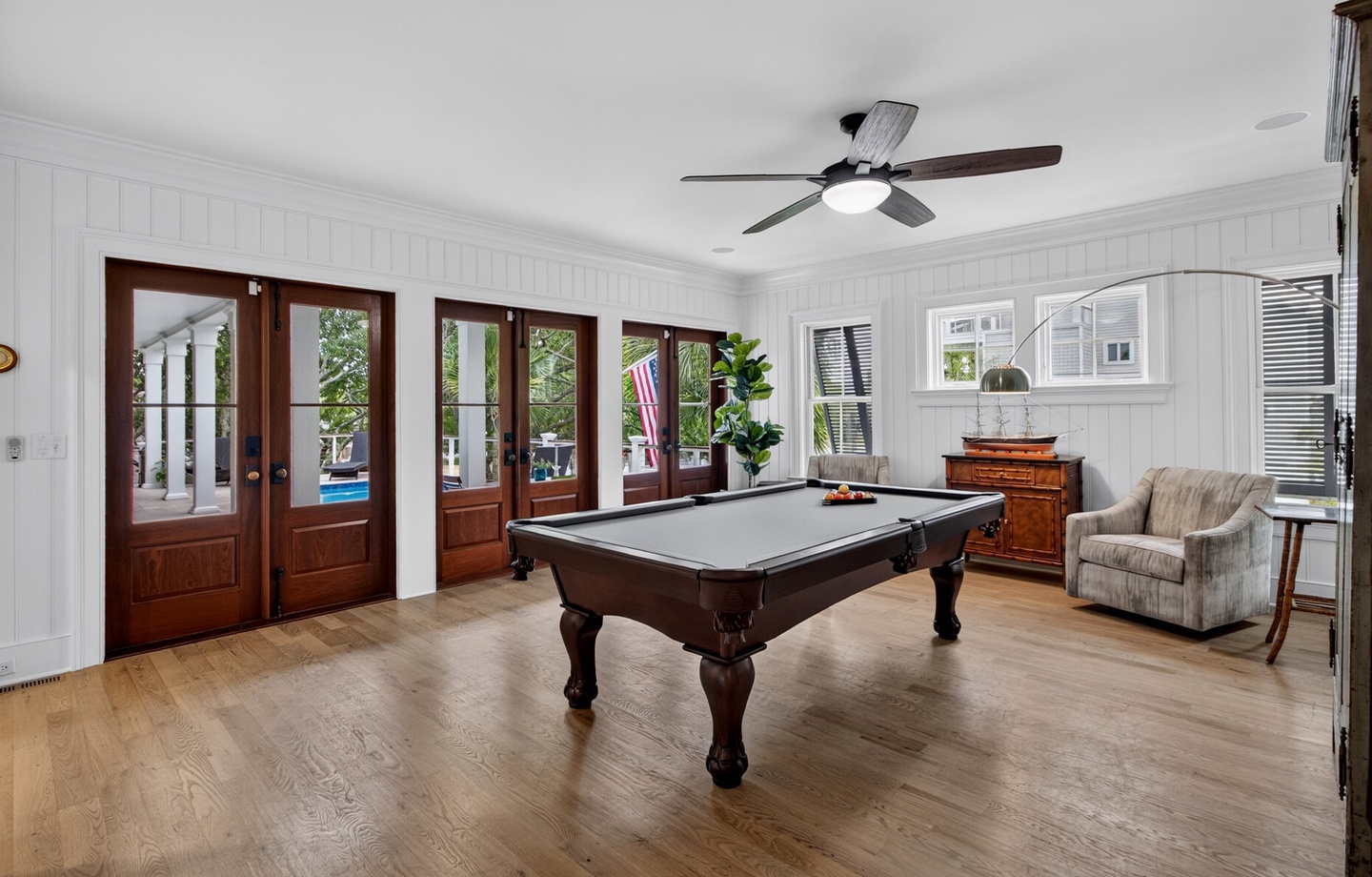 Challenge your travel companions to a friendly game of pool in this elegant game room, where natural light streams through glass doors opening to your private outdoor space.