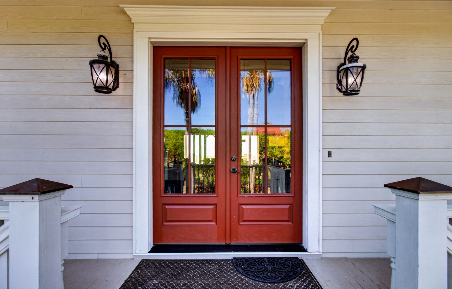 Elegant double doors with tropical views welcome you to your coastal retreat.