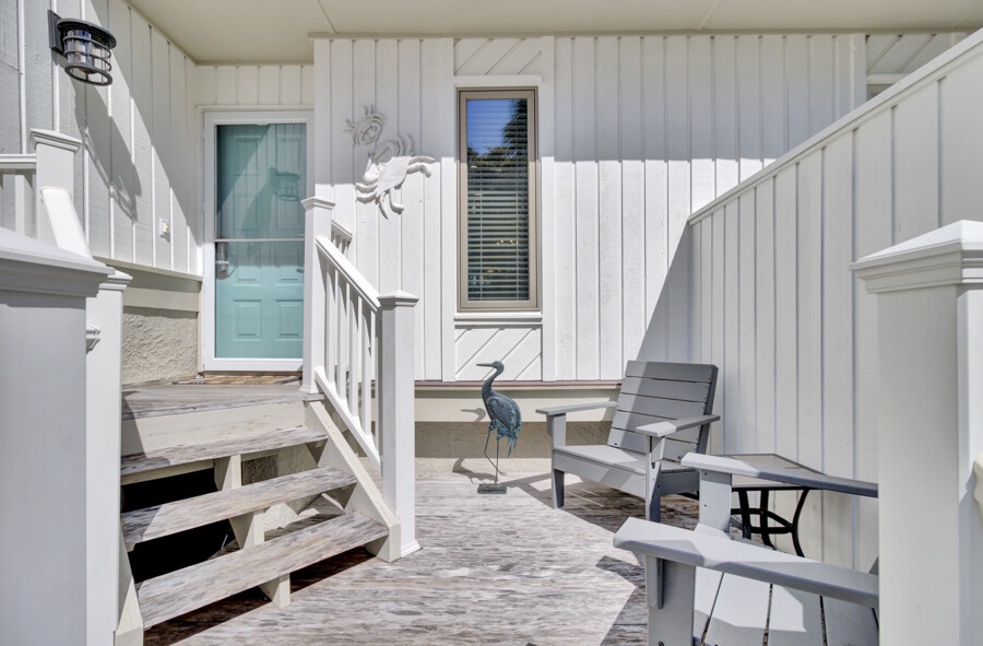 Your private patio offers a peaceful spot to unwind, with comfortable seating and charming coastal décor that welcomes you home after a day of exploring.