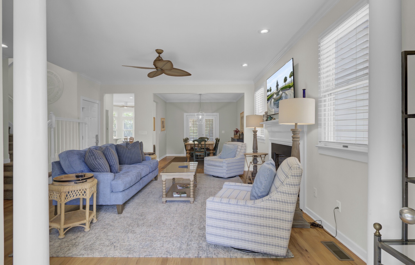 Unwind in your beautifully appointed living space with plush blue seating, warm hardwood floors, and a cozy fireplace for perfect relaxation.