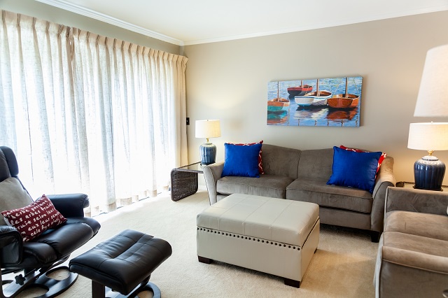 - Kick back on the comfy sectional with plush pillows and feel instantly at home - Vibrant boat art and bold pops of blue add personality to your cozy retreat - Soak in the sunshine pouring through full length curtains after a beach day