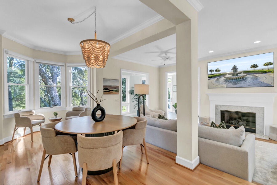 Gather around the elegant dining table, bathed in natural light from oversized windows. The open-concept layout flows seamlessly into a cozy living room, making every moment feel effortlessly connected.