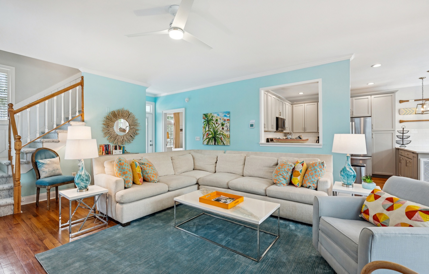 Sink into this stylish sectional where turquoise walls and coastal accents create your perfect seaside retreat atmosphere.