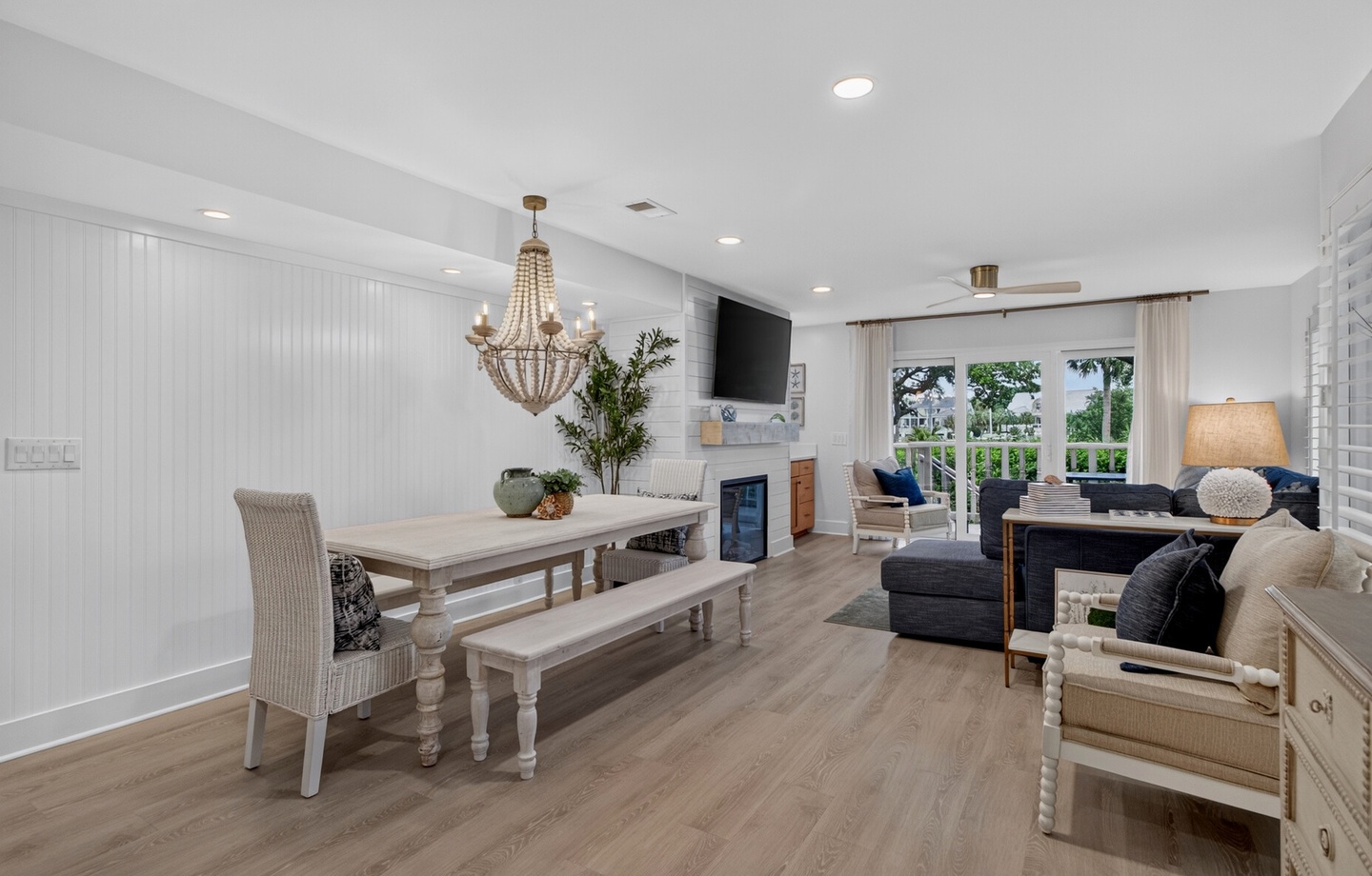 Relax in this bright, open-concept space where coastal charm meets modern comfort. Enjoy meals at the rustic dining table, unwind on plush seating, and step out to your private outdoor retreat through elegant French doors.