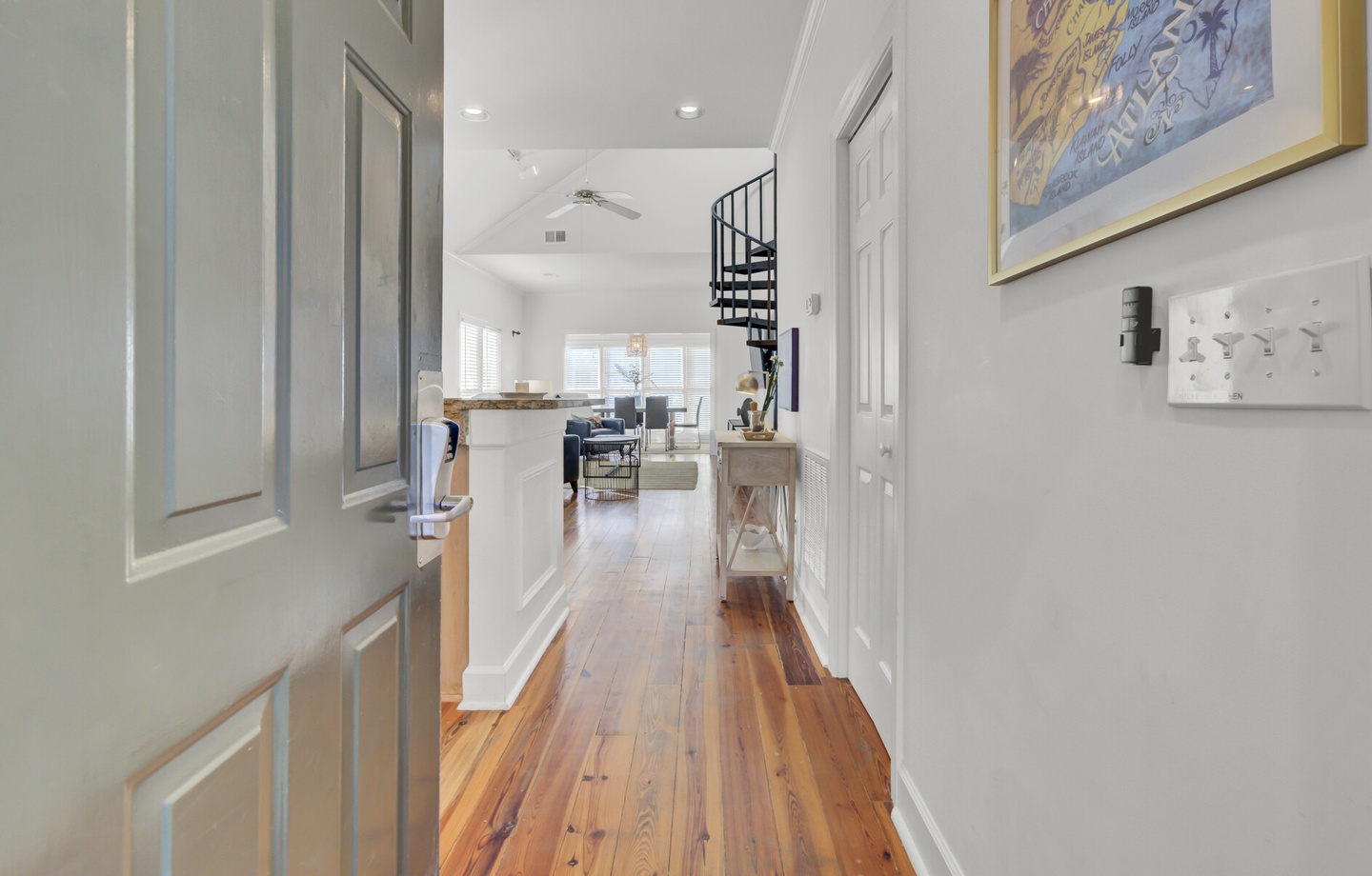 Step into your stylish retreat where warm hardwood floors flow through bright, open spaces adorned with coastal artwork and modern touches.