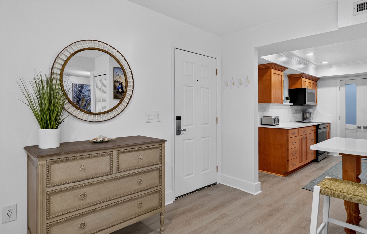 Step into your bright, open living space with coastal touches and a fully equipped kitchen ready for your stay.