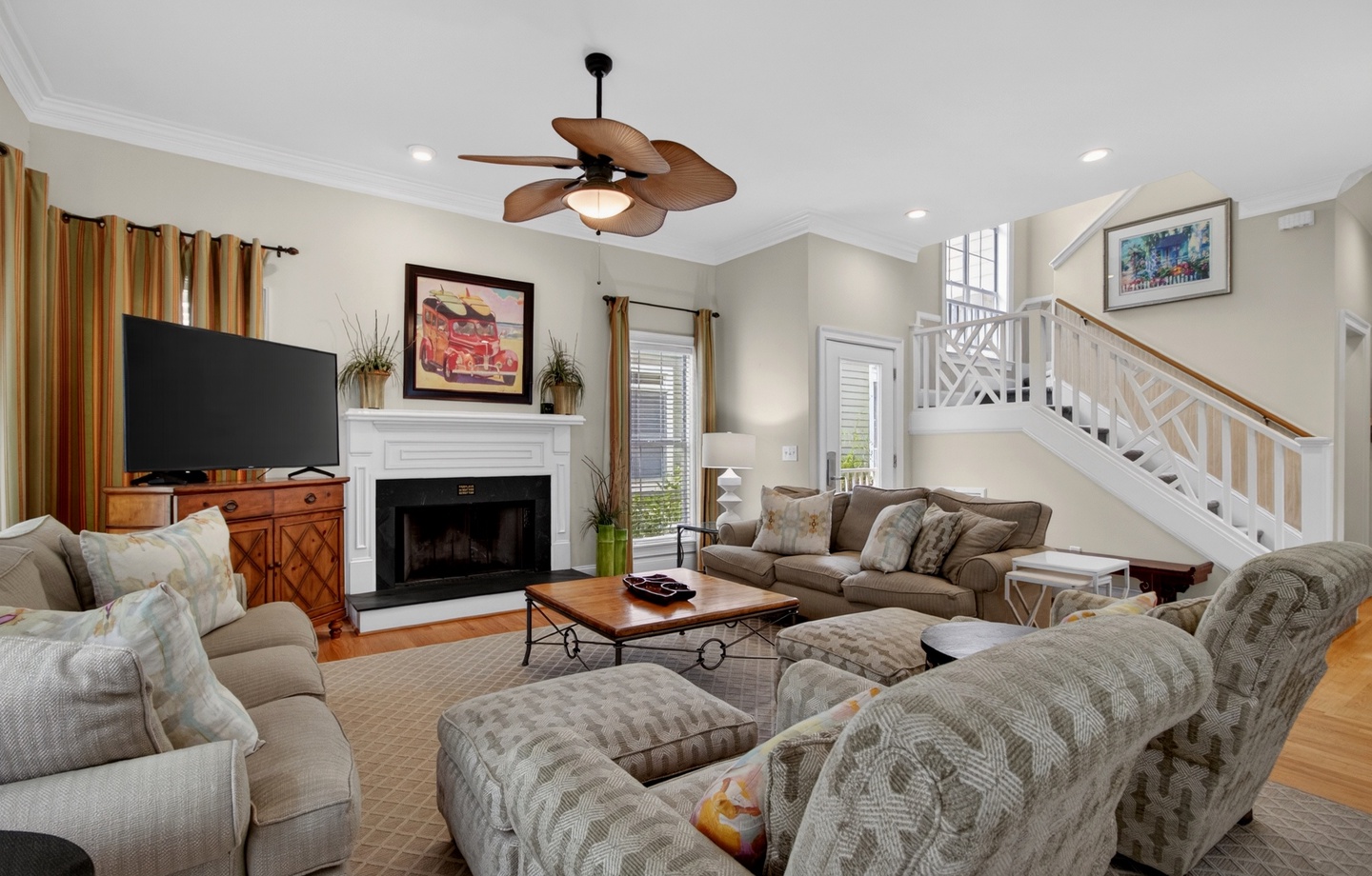 Gather with loved ones in this spacious living room, where vaulted ceilings and a cozy fireplace create the perfect setting for relaxing evenings together.