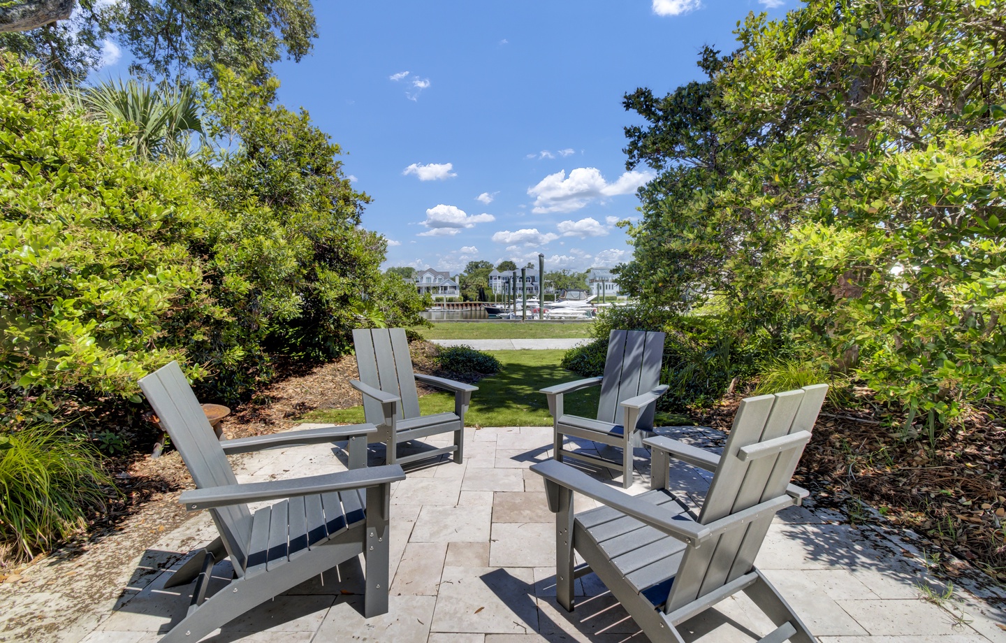 Unwind in this peaceful seating area surrounded by lush landscaping, where comfortable chairs invite you to relax and enjoy tranquil garden views.
