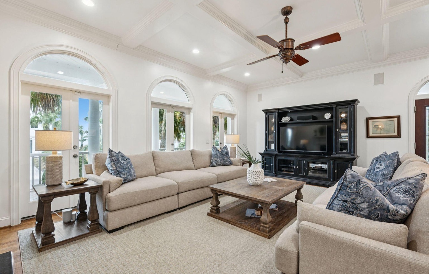 Relax in this elegant living room with plush seating, coffered ceilings, and French doors opening to your private balcony.