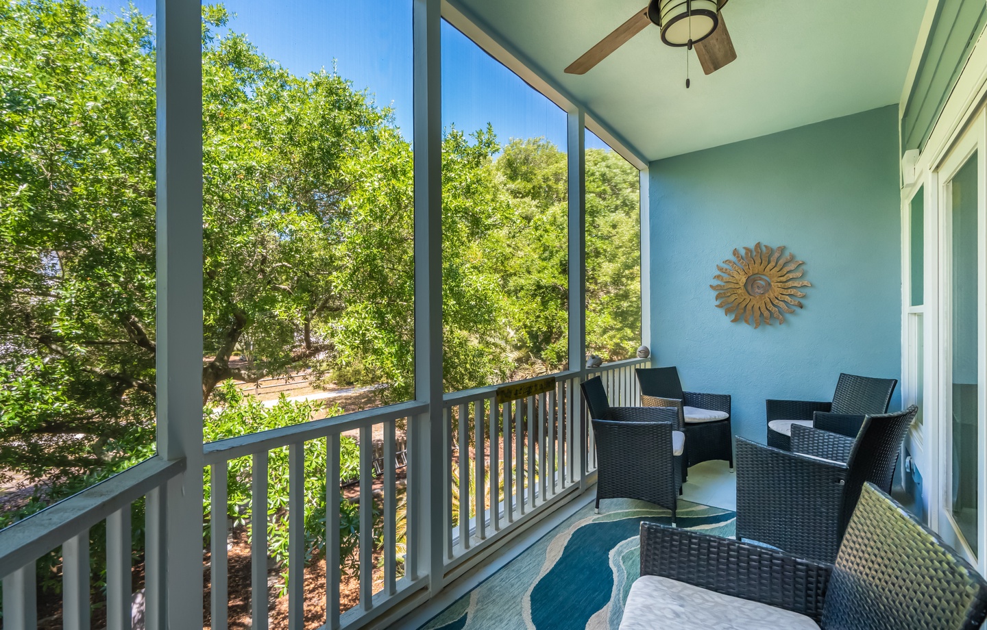 Unwind in your private screened porch with garden views, where a ceiling fan keeps you comfortable and stylish seating invites morning coffee or evening conversation.