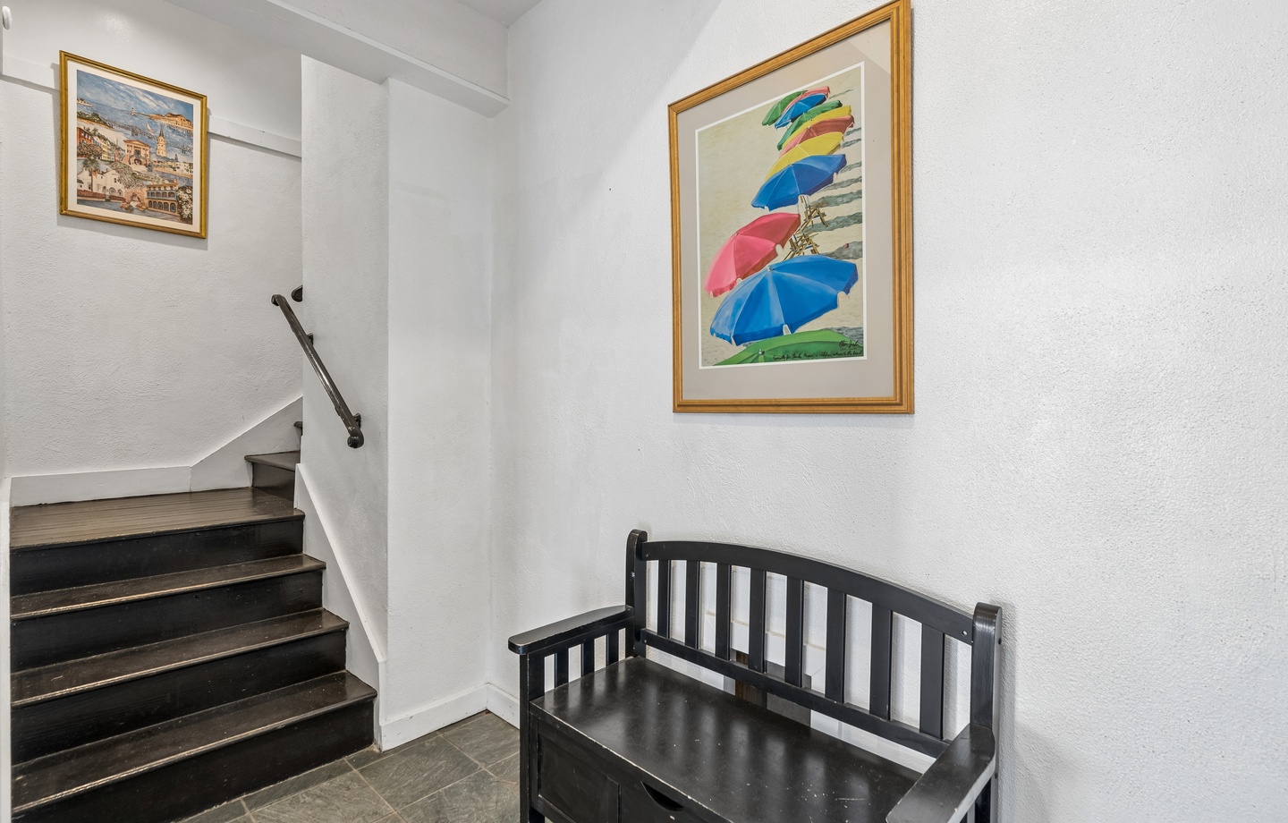 Discover charming coastal artwork and thoughtful touches in your stairway, featuring colorful beach umbrellas that capture the seaside spirit.