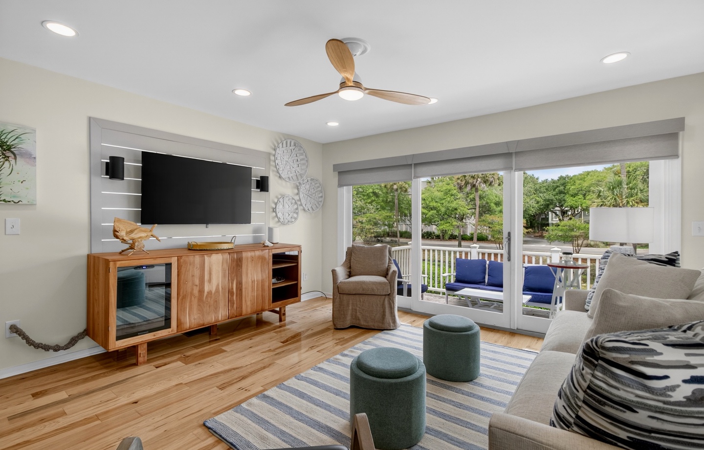 Picture yourself unwinding in this bright living room, streaming your favorite shows while enjoying views of the lush outdoor deck through sliding glass doors.
