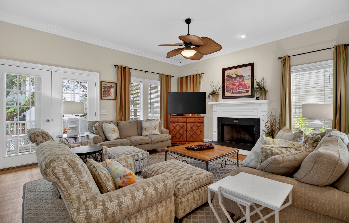 Settle into plush seating in this inviting living room, where you can gather with loved ones by the fireplace or step through French doors to your private deck.