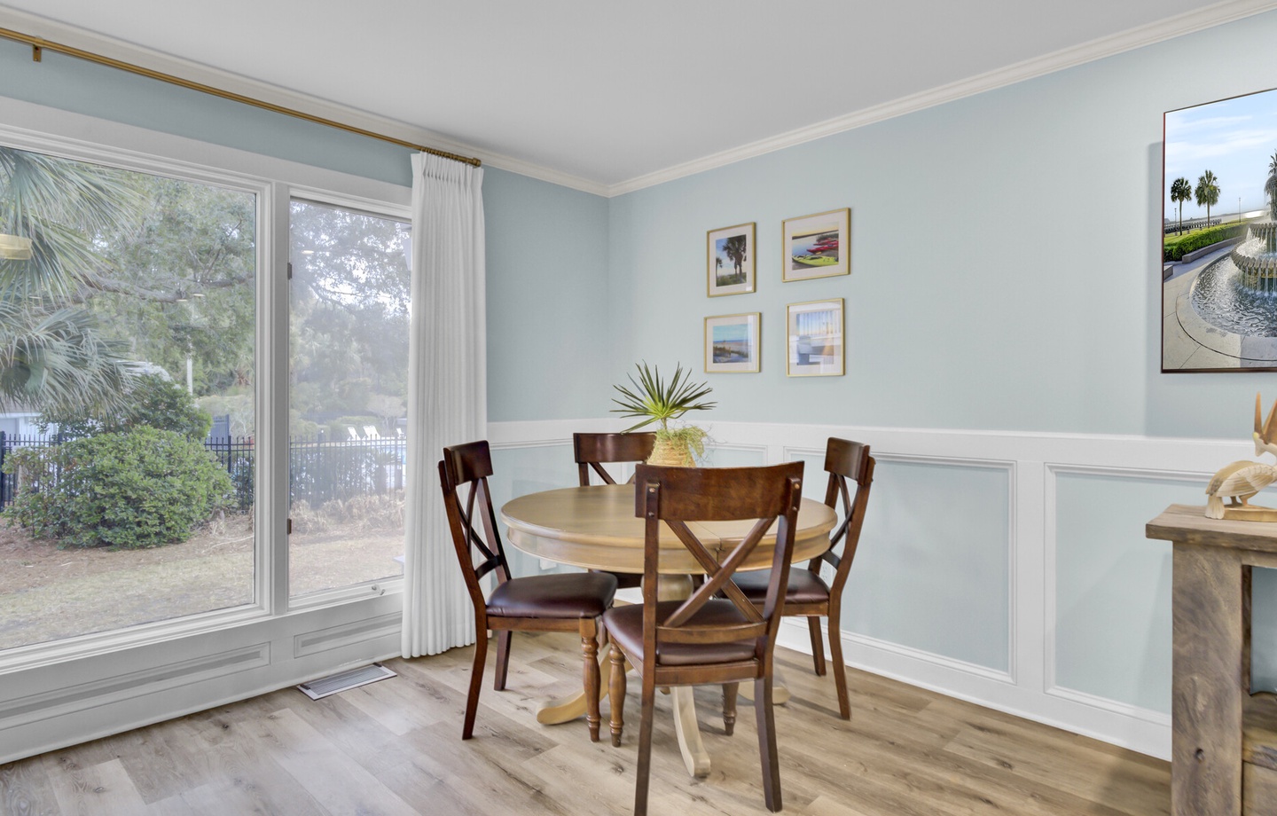 Enjoy meals in your bright dining nook with garden views and coastal-inspired decor that creates a peaceful breakfast spot.