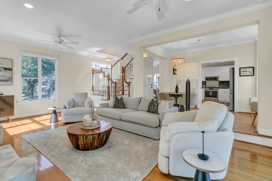 Sink into plush seating in this bright, airy living room where warm wood floors and natural light create your perfect retreat for relaxation and conversation.