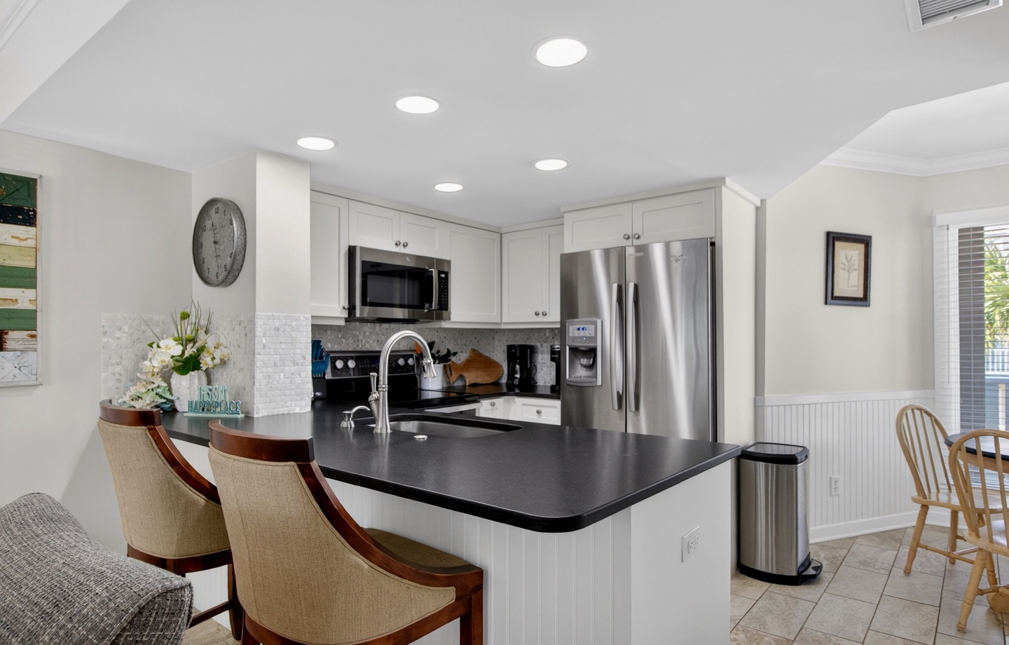 Step into your fully-equipped kitchen with sleek countertops, modern appliances, and a breakfast bar perfect for morning coffee or casual meals together.