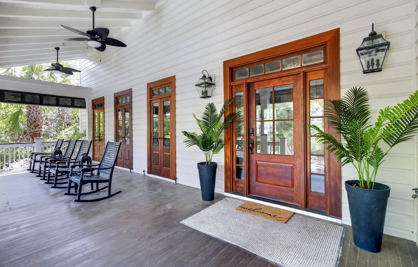 Step onto your welcoming covered porch where ceiling fans and rocking chairs create the perfect spot to unwind with tropical breezes.