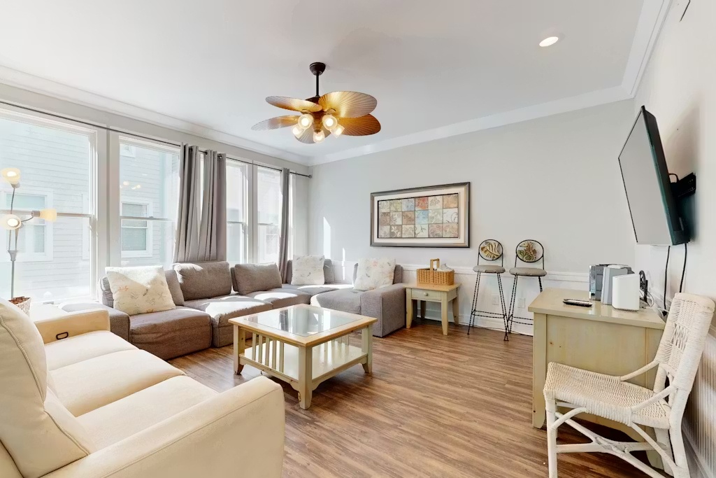 Settle into your spacious living room with plush sectional seating, natural light streaming through large windows, and modern amenities for perfect relaxation.