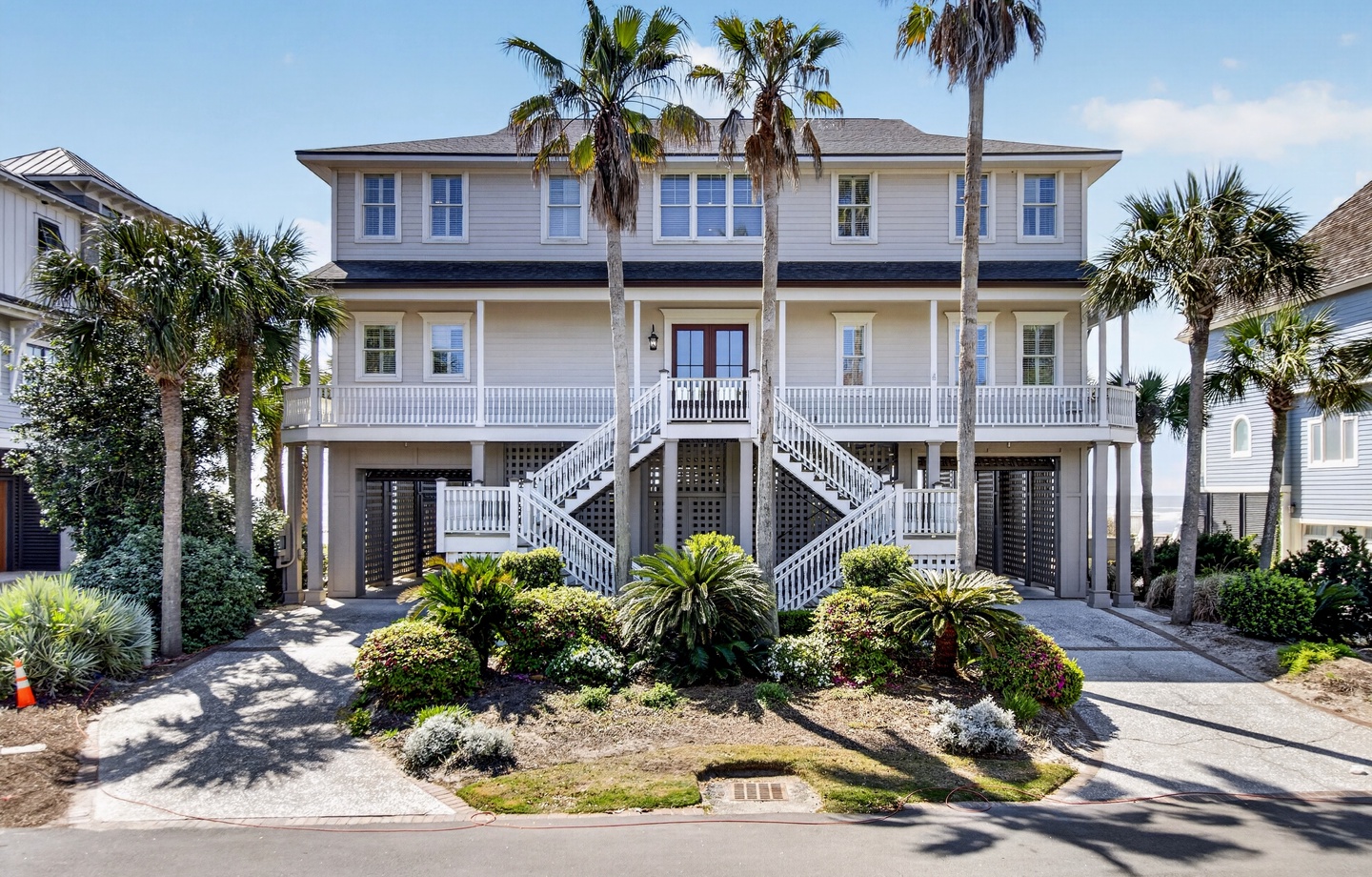 Elegant coastal property featuring tropical landscaping and elevated architecture in a charming residential setting.