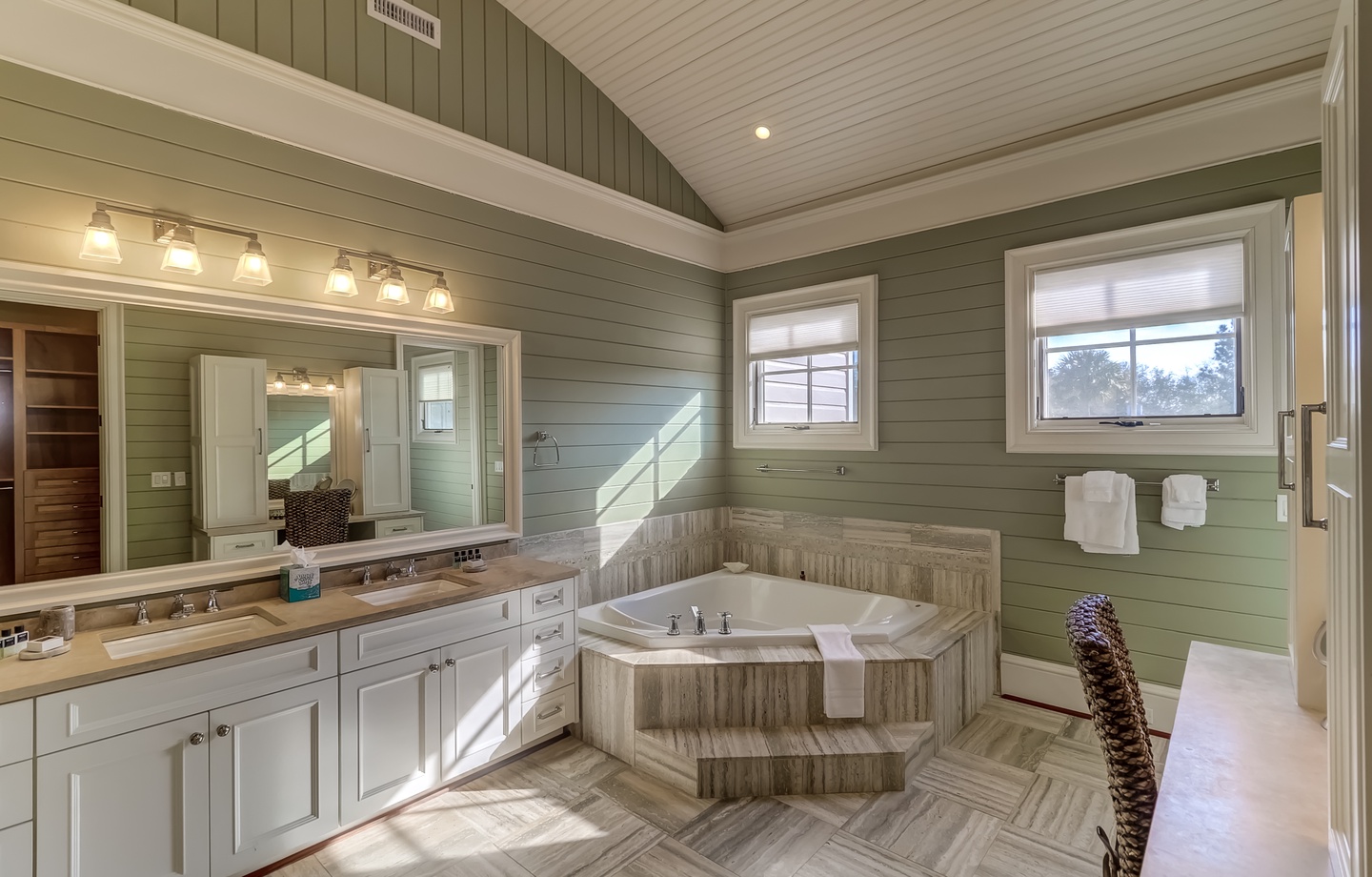 Unwind in your spa-like master bathroom featuring a soaking tub, dual vanities, and elegant coastal design.