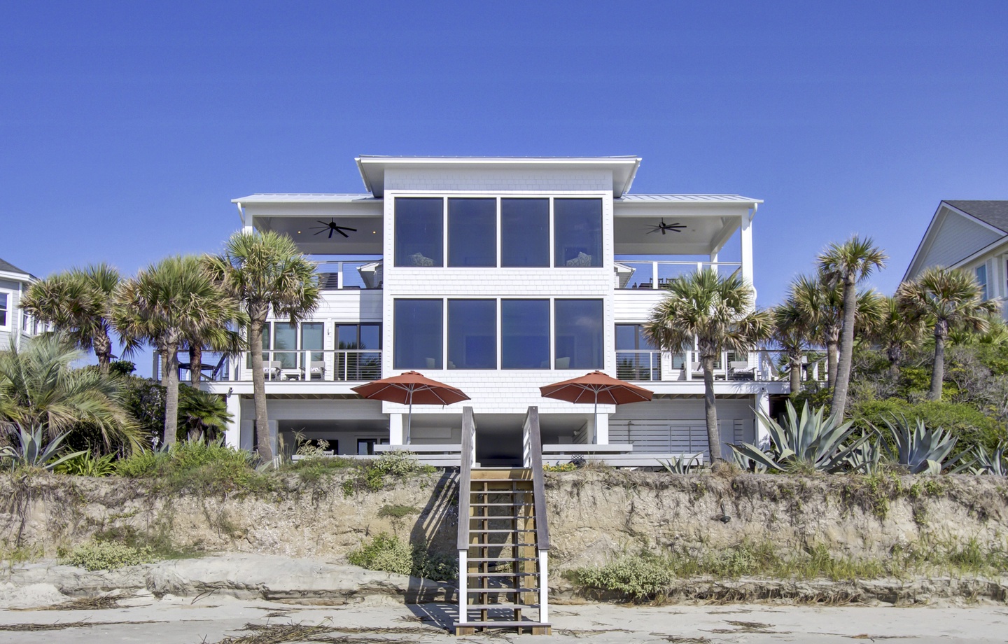 Stunning beachfront villa with panoramic windows, wraparound terraces, and direct beach access.