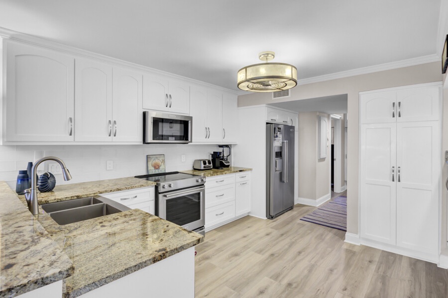 Your fully equipped kitchen features granite countertops, modern appliances, and ample storage for creating memorable meals during your stay.