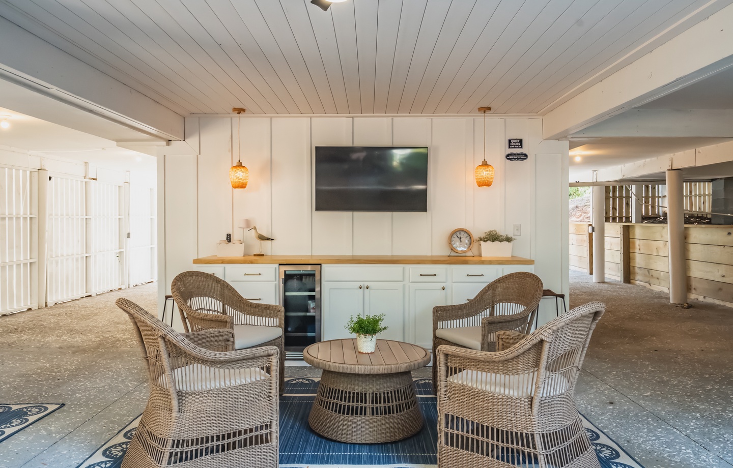 Gather in this charming communal space, where wicker chairs invite you to relax with friends and the warm wood accents create a welcoming atmosphere perfect for unwinding together.