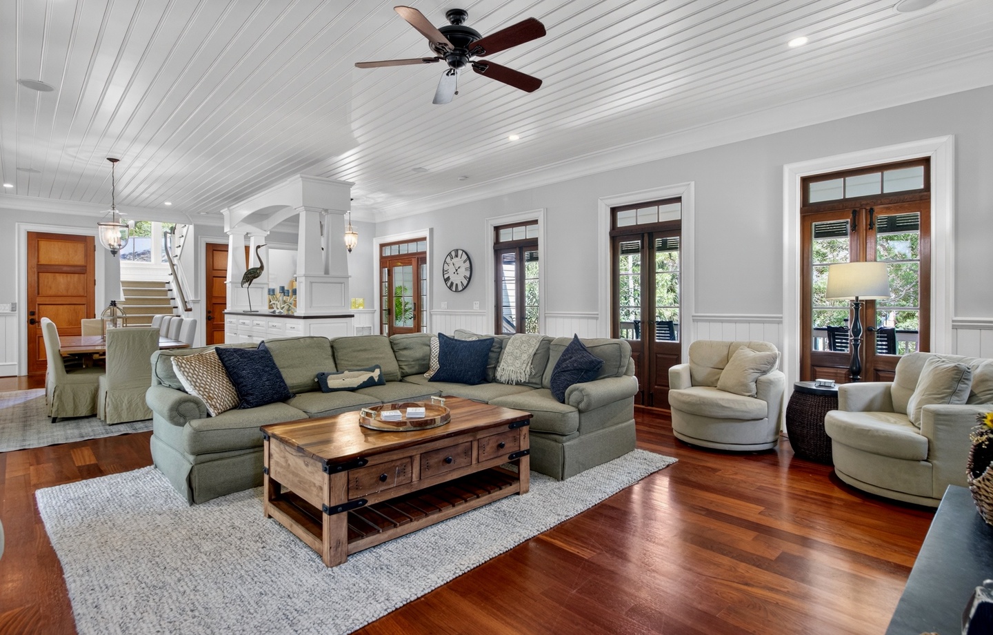 Sink into plush seating surrounded by gleaming hardwood floors and soaring ceilings, where natural light streams through elegant windows.