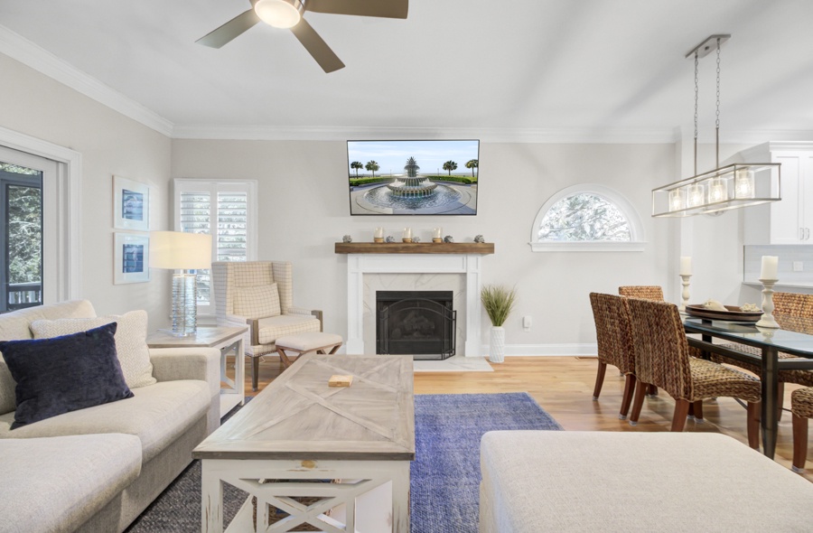 Unwind in this bright, coastal-inspired living space where you'll find cozy seating by the fireplace and an open layout perfect for relaxing.