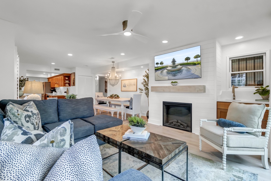 Sink into plush seating and let the coastal vibes wash over you. This bright, open living space features a cozy fireplace and flows effortlessly into the kitchen—perfect for your group's downtime together.