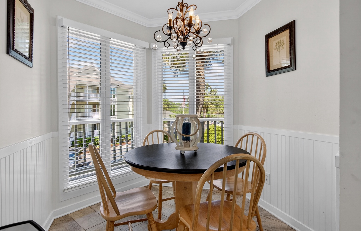 A sun-filled dining nook with charming neighborhood views and an elegant chandelier sets the scene for your morning coffee or intimate dinners during your stay.