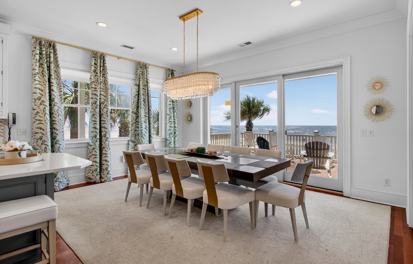 Your stunning dining room showcases ocean views through expansive windows, creating the perfect backdrop for memorable meals with family and friends.