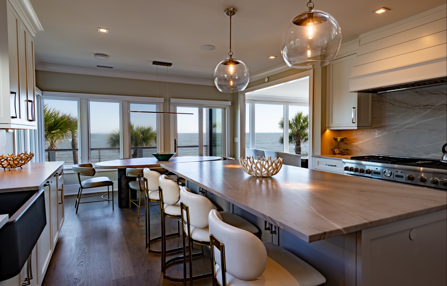 - Enjoy ocean views while cooking or dining at this sleek island with designer lighting - Gourmet kitchen with stainless steel appliances and spacious counters - Coastal elegance meets comfort in this inviting open concept space