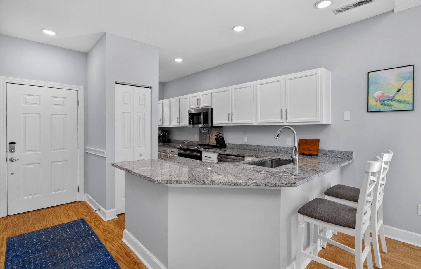 Your modern kitchen features granite countertops, stainless appliances, and a breakfast bar perfect for morning coffee or casual meals.