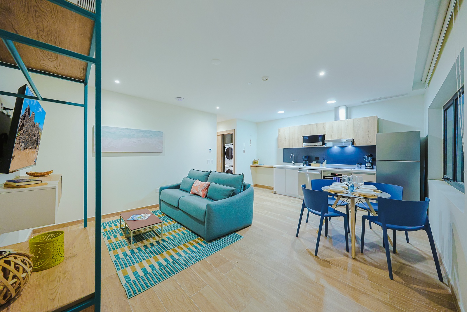 Step into your private open-plan retreat with modern touches and calming coastal hues. Relax in the cozy living area or gather around the dining table for a meal.