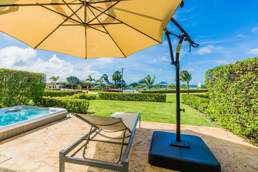 Patio w/ umbrella and lounge chair