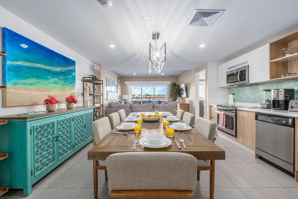 Gather around this bright, coastal-inspired space where every meal feels like a celebration. The open kitchen and inviting dining table make your vacation mornings effortless and memorable.