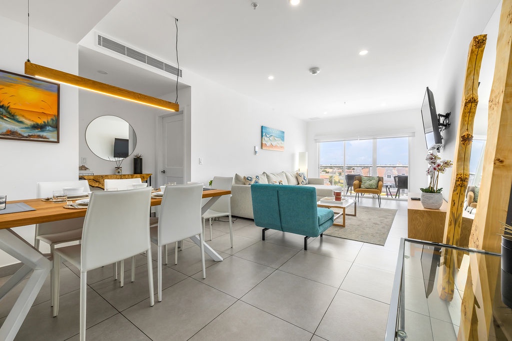 Bright open-plan living flows effortlessly from dining to lounge, where your windows frame city views and natural light fills every corner.