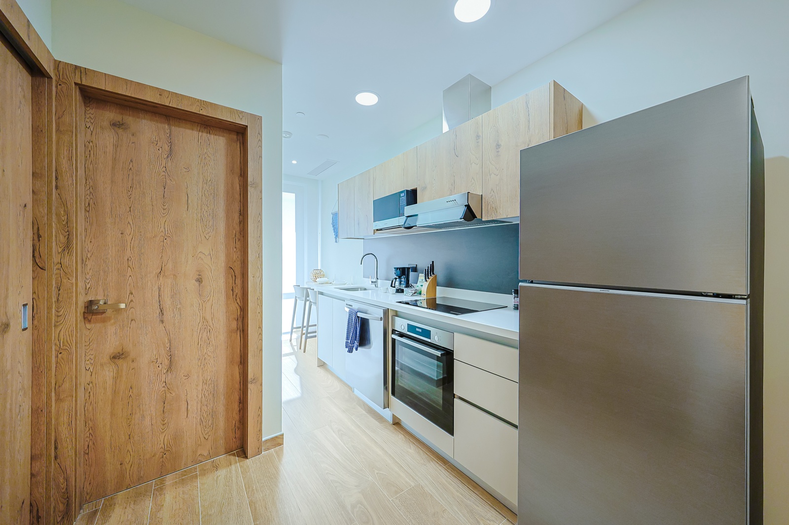 Your sleek modern kitchen offers everything you need to prepare fresh meals, with stainless appliances, ample counter space, and natural light streaming through the open layout.
