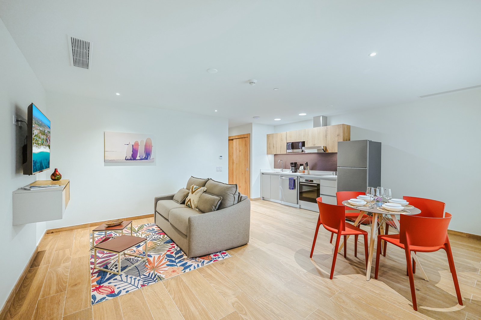 Step into your light-filled retreat, where modern design meets comfort. Unwind on your plush sofa, whip up meals in the sleek kitchen, and gather around the vibrant dining table for memorable moments during your stay.